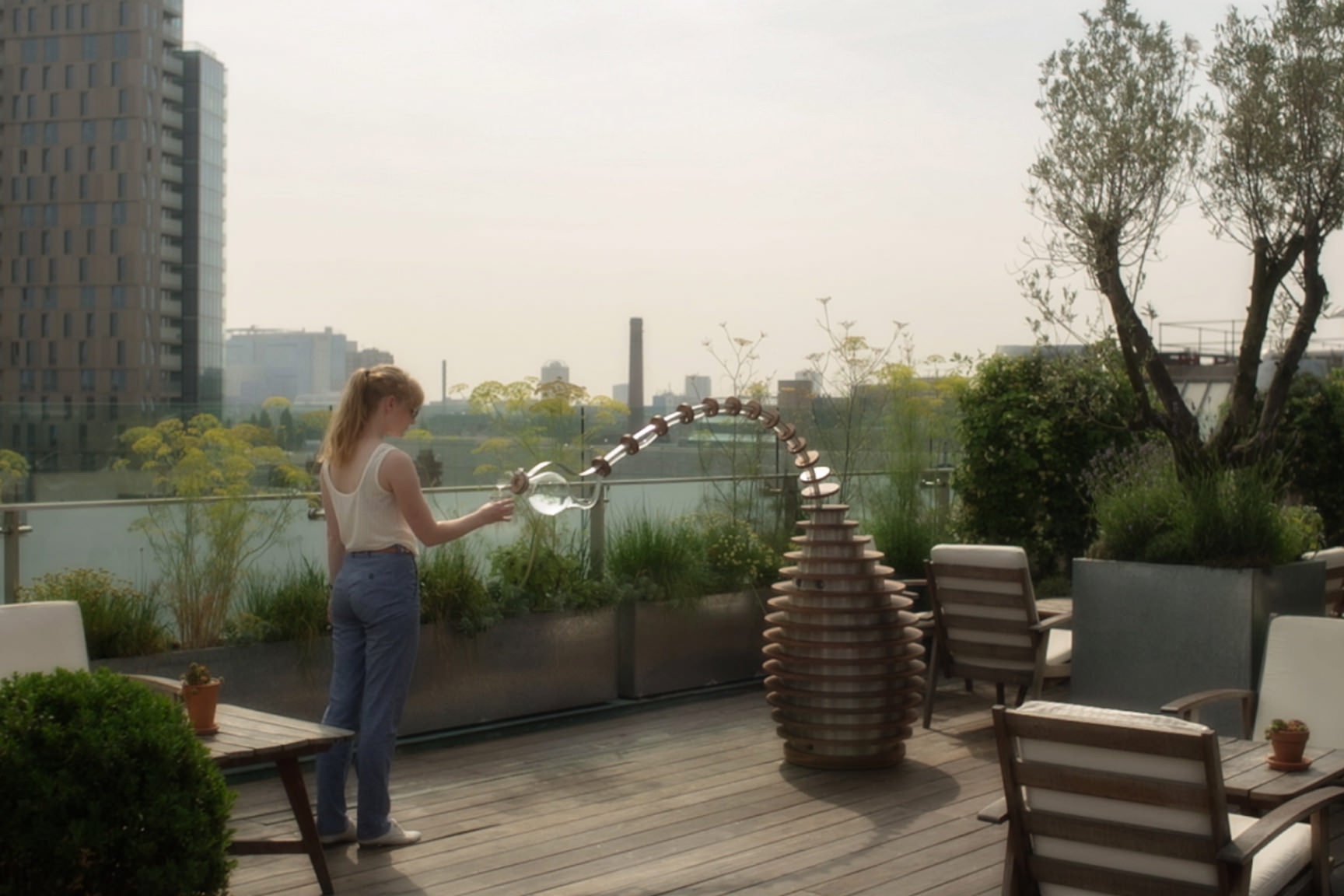 Tropism Well on a roof top pouring someone a drink